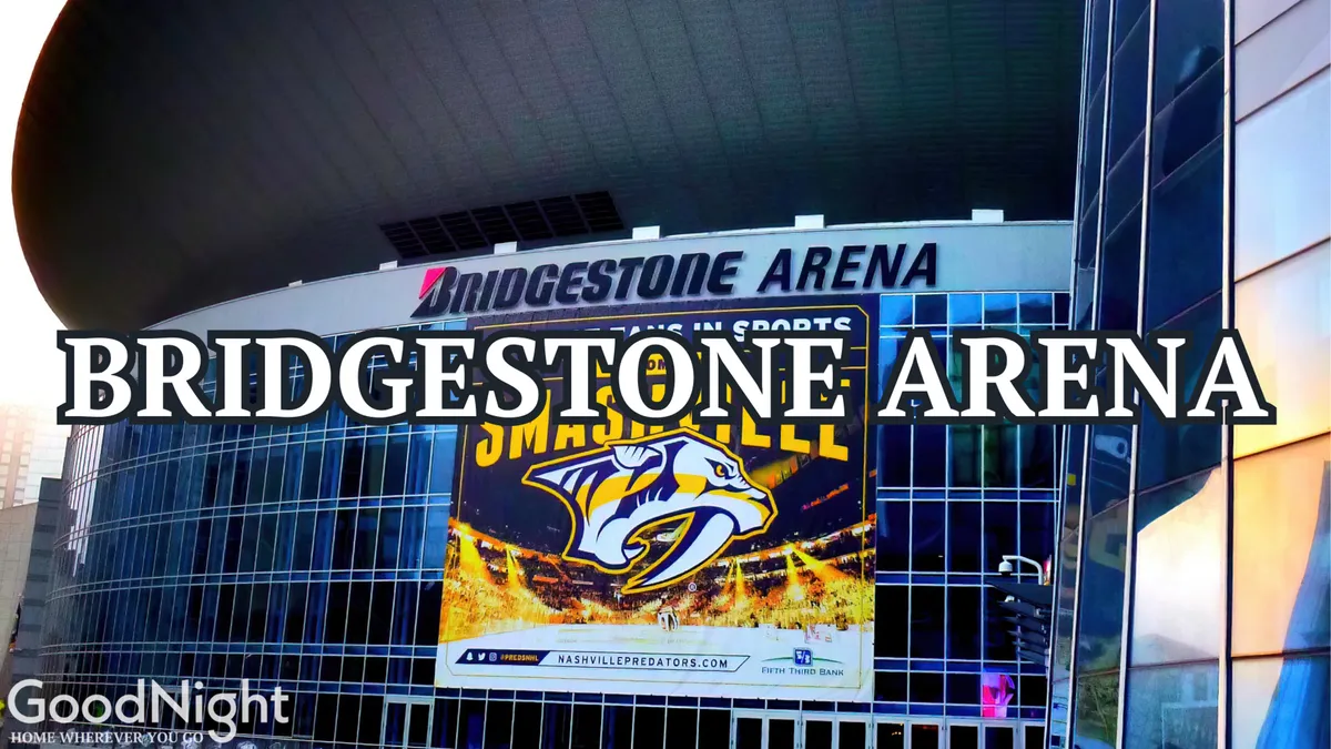 The impressive glass facade of Bridgestone Arena with its prominent sign and a large event banner. The arena sits at the heart of downtown, suggesting easy access for both business and entertainment events.
