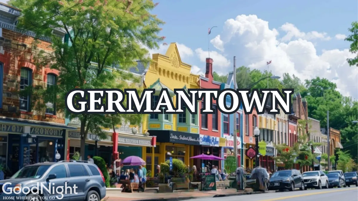 A vibrant, tree-lined street in Germantown, bustling with people enjoying outdoor cafe seating and colorful storefronts. The lively atmosphere suggests trendy eateries and a welcoming neighborhood for exploration after a day on the course.